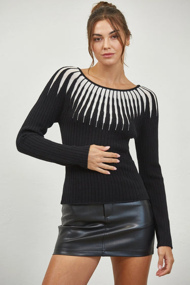 Woman wearing a black ribbed knit sweater with white contrast neckline, long sleeves, and slim fit — Aurora Sweater by Matte.
