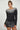 Editorial shot of the Aurora Sweater styled for a chic fall look, black ribbed knit with contrast neckline, Matte fashion.