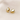 Aurore Huggie Earrings, gold domed huggie hoop earrings with smooth rounded silhouette and polished mirror finish, photographed on white linen background with soft editorial lighting.
