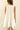 Model wearing Nara Mini Dress in white with halter neckline and relaxed fit.
