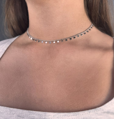 Model wearing Belen silver star charm choker necklace close-up