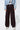 Front view of Lisboa Pants styled with denim jacket and sneakers.