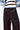 Waist detail of Lisboa Pants with button and pleated front.