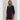 Model wearing black Krewer Dress with puff sleeves and relaxed mini silhouette.