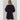 Model wearing black Krewer Dress with puff sleeves and relaxed mini silhouette.