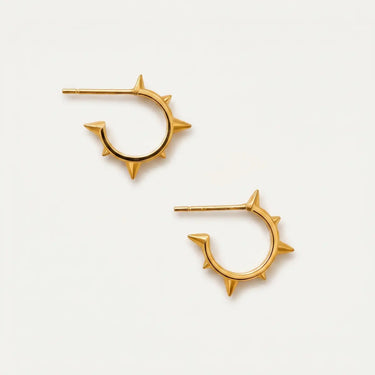 Bodil Hoop Earrings featuring polished gold-plated mini hoop earrings with sleek spike accents, lightweight open-hoop design, secure hinged closure, smooth mirror finish, and modern edgy silhouette on a soft white background.