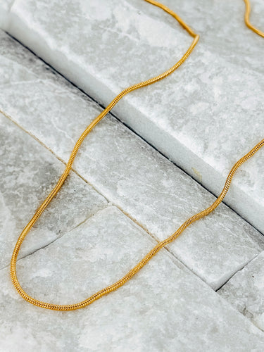 Boreal Necklace by Matte, 18K gold filled adjustable snake chain displayed on marble background