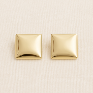 Brume Huggie Earrings, gold square huggie earrings with softly domed pillow shape and polished mirror finish, photographed on white linen background with soft editorial lighting