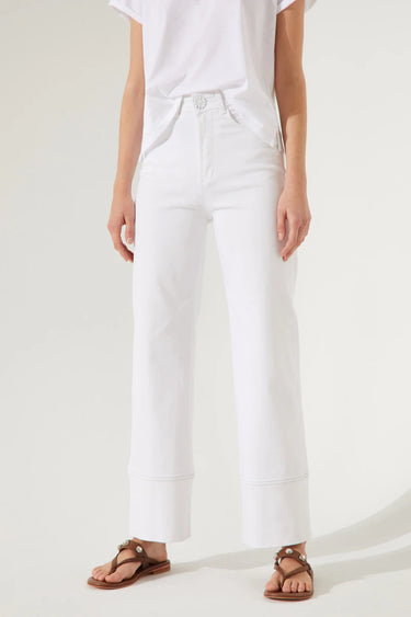 Model wearing Camelia Jeans in white high-rise wide-leg fit.