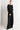 Woman wearing black pants with button details on a white background