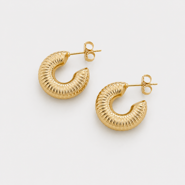 Caroline Hoop Earrings featuring polished gold-plated chunky hoop earrings with a textured ribbed finish, rounded silhouette, mirror shine, secure post-back closure, lightweight design, and bold everyday style.