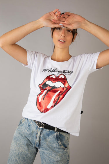 Model wearing the Electric Soul Shirt — white vintage graphic tee with red Rolling Stones tongue design, styled with relaxed jeans and black belt, close up.