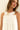 Model wearing Nara Mini Dress in white with halter neckline and relaxed fit, close up