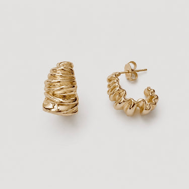 Conte Hoop Earrings featuring polished gold-plated hoop earrings with an organic crinkled texture, sculptural rounded hoop silhouette, high-shine finish, secure hinged closure, lightweight design, and bold everyday statement style.