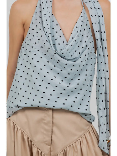 Close-up of the Cristine polka dot fabric and draped neckline.
