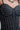 Detailed view of crystal embellishments on black corset top, highlighting sparkle.
