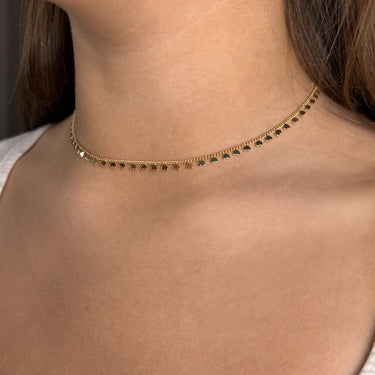 Dalia necklace gold plated heart charm chain on textured beige fabric background
