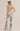 Silver sequin pants with bold green and red lightning bolt detail, high-waisted flared fit, back view