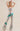 Silver sequin pants with bold green and red lightning bolt detail, high-waisted flared fit.