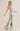 Silver sequin pants with bold green and red lightning bolt detail, high-waisted flared fit, side view