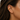 Debbie Ear Cuff worn on ear showing no-piercing fit and bold gold stacked jewelry look.