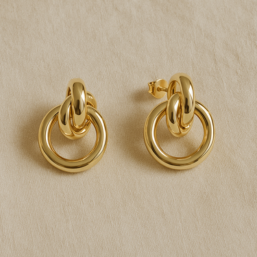 Douce Stud Earring, gold stud earrings with linked double hoop design and polished mirror finish, photographed on white linen background with soft editorial lighting.