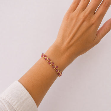 Model wearing the Efi Bracelet in blush pink featuring delicate polished beads on a fine adjustable chain for a soft feminine look.