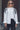 Elaine Shirt front view featuring crisp white fabric, collar neckline, and black embroidery.