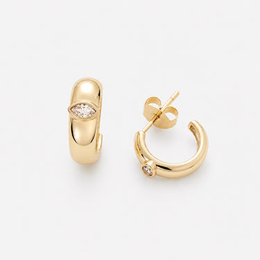 Eleonora Hoop Earrings featuring polished gold-plated mini hoop earrings with a smooth rounded silhouette, sparkling pavé crystal accent, mirror finish, secure hinged closure, lightweight design, and elegant everyday style, displayed on a soft white background.