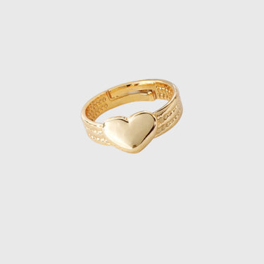 Elif Gold ring with a heart design on a light gray background by Matte