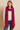 Woman wearing the Eto Pashmina in fuchsia chunky knit wool, vibrant texture, cozy editorial photo – Matte.