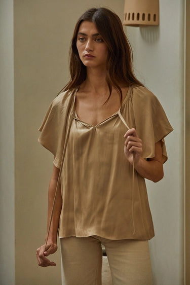 Etta Blouse front view showing soft tie neckline and lightweight flowy fit in warm neutral tone.