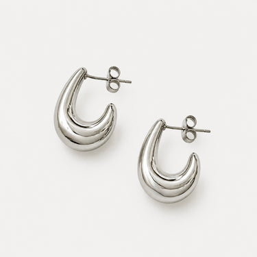 Etterbeek Hoop Earrings featuring polished silver-plated sculptural hoop earrings with a layered teardrop silhouette, smooth mirror finish, lightweight hollow design, secure post-back closure, and modern statement style.