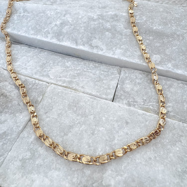 Fera gold filled linked chain necklace by Matte on marble background
