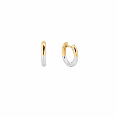 Filippa Huggie Earrings gold and silver huggie hoop earrings displayed on neutral background.