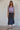 Full-length styling of the Fishnet Top paired with a midi skirt.