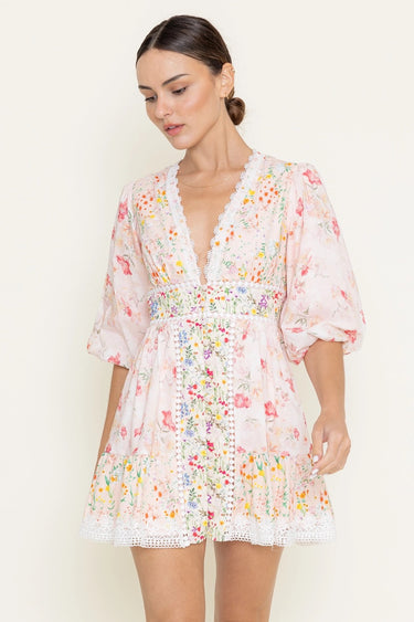 Woman wearing a floral dress against a white background