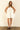 Model wearing Nara Mini Dress in white with halter neckline and relaxed fit.