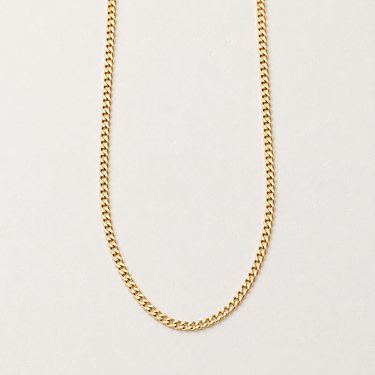 Gatmi Necklace featuring a gold-filled Cuban chain with polished interlocking links, styled on a white background showcasing its timeless design and smooth, reflective finish.
