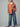 Woman wearing the Genova oversized peach corduroy jacket with plush lining, blue wide-leg jeans, white mock-neck top, and black sneakers.