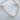 A gold-plated bracelet with white pearls and gold beads, displayed against a white background.