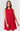 A woman wearing a vibrant red, sleeveless summer dress with a floral eyelet pattern, featuring a button-down front.