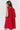 Model wearing red Gigi Dress with sleeveless cut and eyelet texture, back view