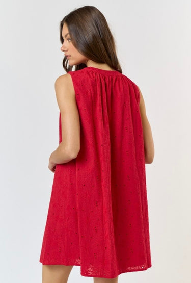 Model wearing red Gigi Dress with sleeveless cut and eyelet texture, back view