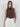 Gladstone Blouse chocolate brown sleeveless scarf-back top styled with white wide-leg trousers.