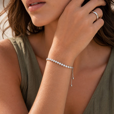 Model wearing the Godiv Bracelet featuring brilliant simulated diamonds on an adjustable chain.