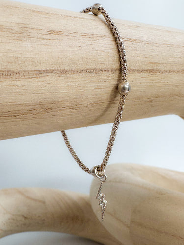Gold Monk bracelet with lightning charm on textured chain – Matte Jewelry