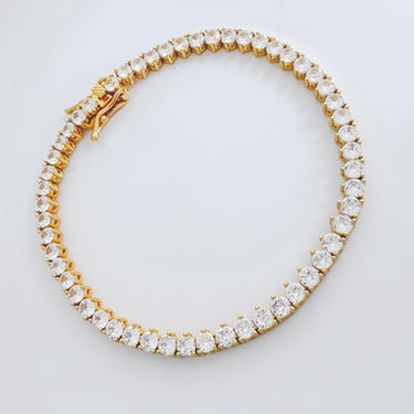 Greek bracelet gold plated tennis style with round cubic zirconia stones by Matte on white background