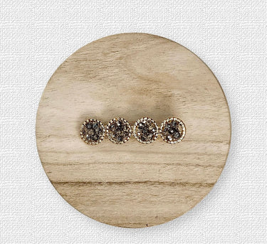 Set of crystal hair clips in grey tones on wood background – Viola Hair Clip by Matte.