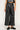 Front view of the Hale Pant in black faux leather featuring a high-rise waist, tailored pleats, and cropped wide legs.